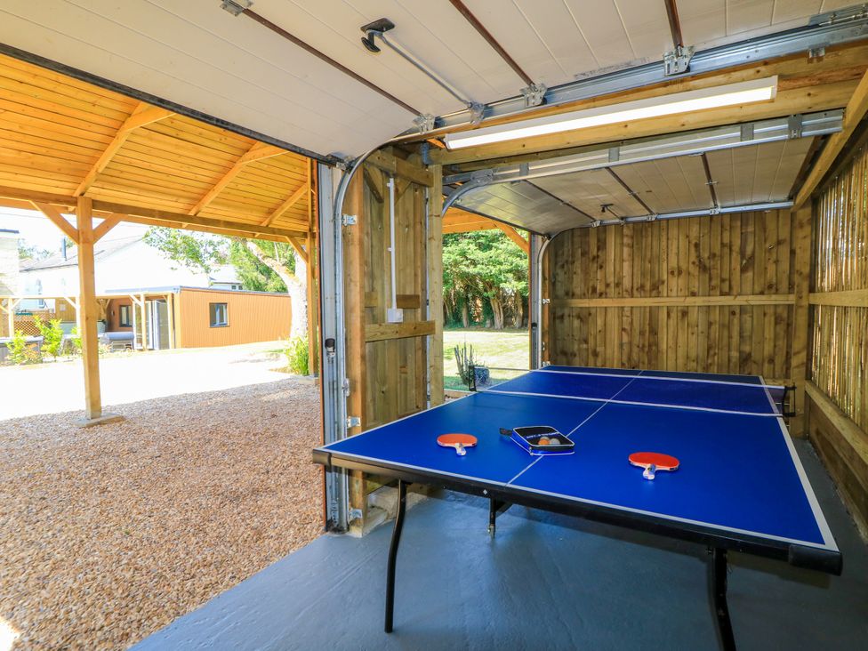 A garage with a table tennis table and outdoor view at Cern-Wyn in Chippenham
