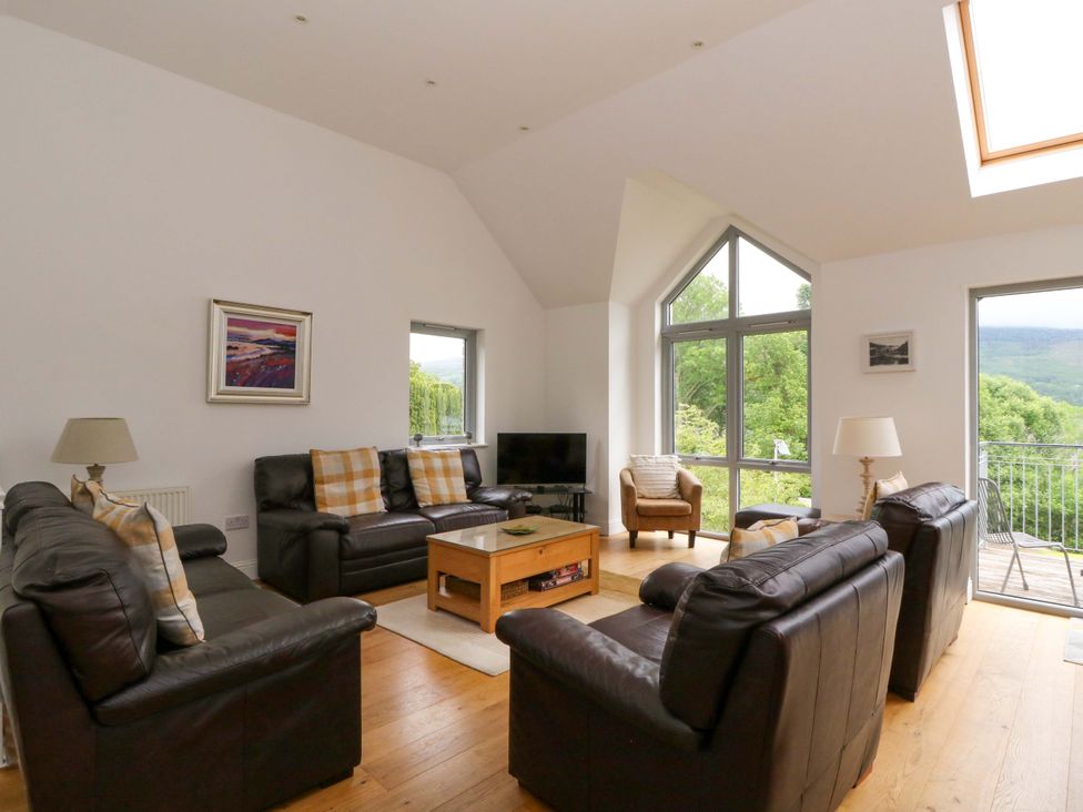 A living room with sofas and a coffee table at Craigard in Aberfeldy