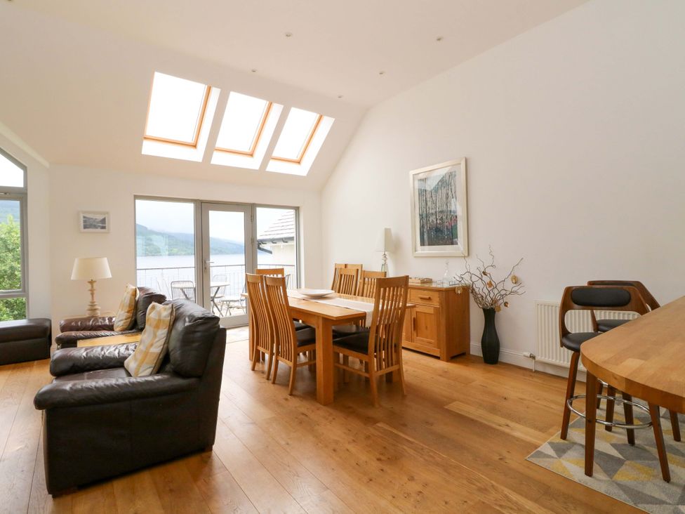 A dining room with a table and chairs at Craigard in Aberfeldy