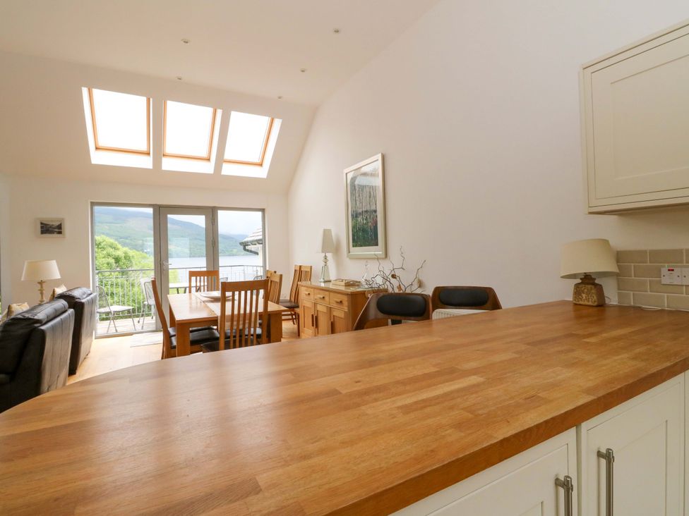 A kitchen with a dining table and sofa at Craigard in Aberfeldy