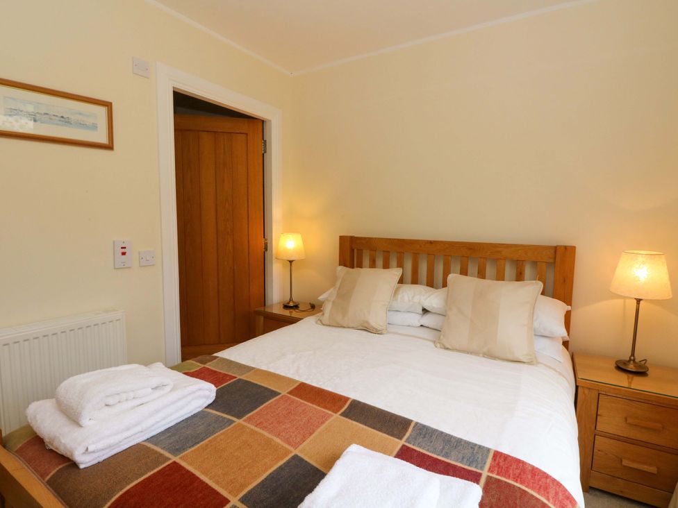 A bedroom with a bed and bedside table at Craigard in Aberfeldy