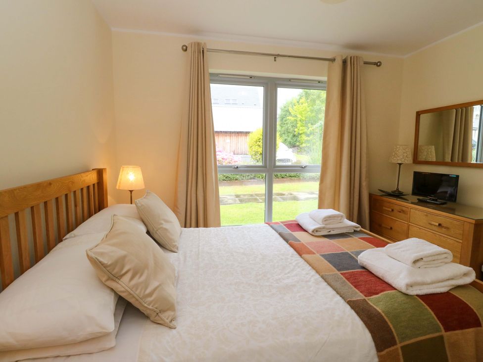 A bedroom with a bed and dresser at Craigard in Aberfeldy