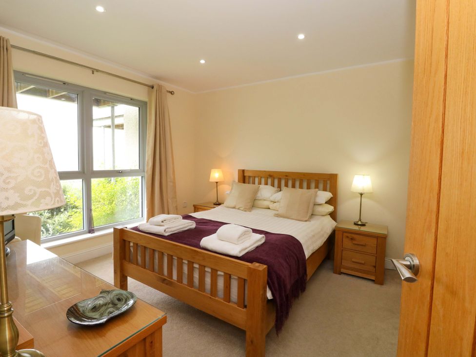 A bedroom with a bed and lamps at Craigard in Aberfeldy