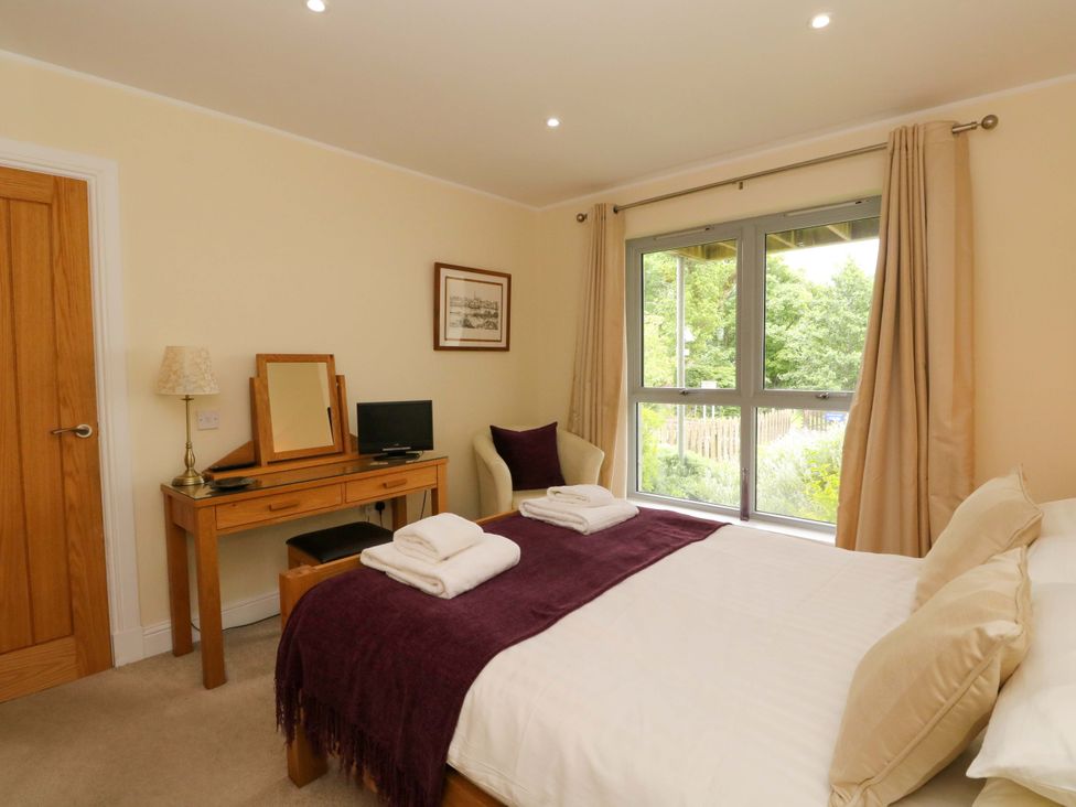 A bedroom with a double bed and a dresser at Craigard in Aberfeldy