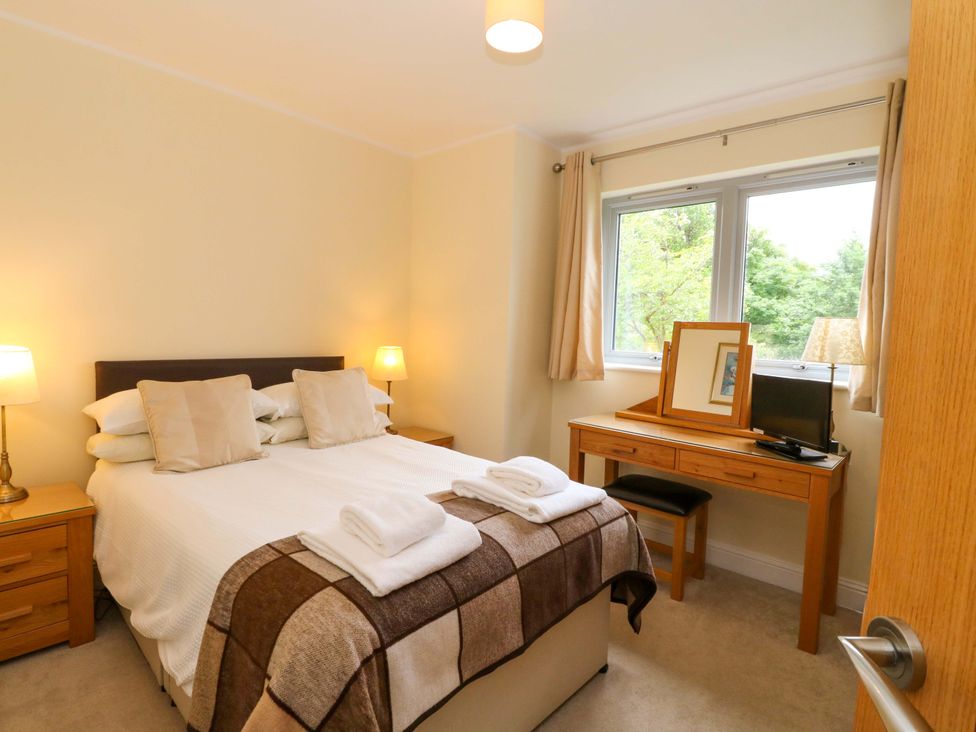A bedroom with a bed and desk at Craigard in Aberfeldy