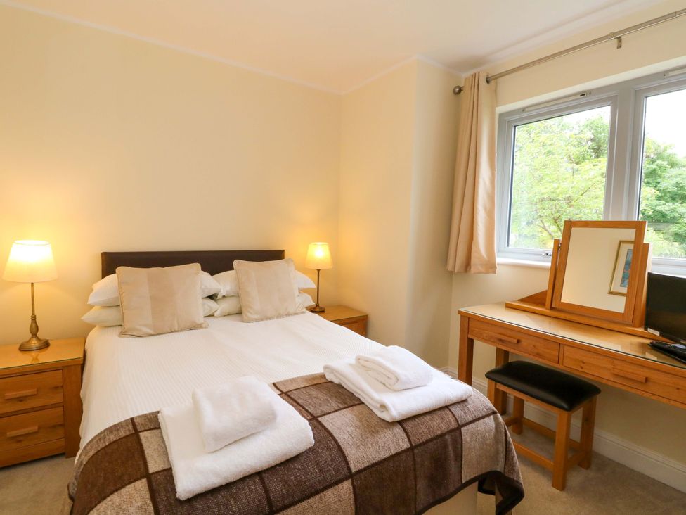 A bedroom with a bed and desk at Craigard Aberfeldy