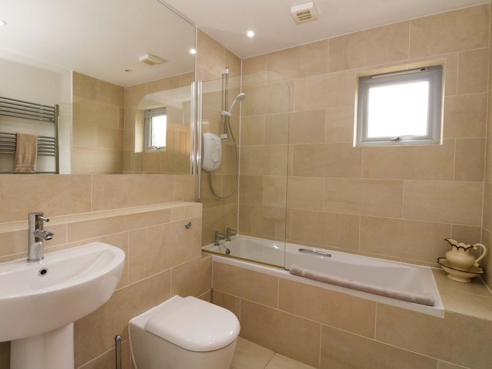 A bathroom with a sink, toilet, and bathtub at Craigard in Aberfeldy