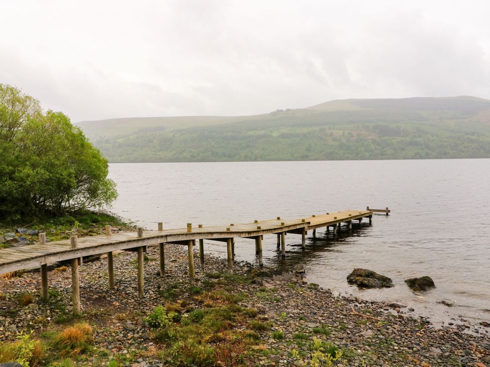 A wooden dock extending into water at Craigard in Aberfeldy