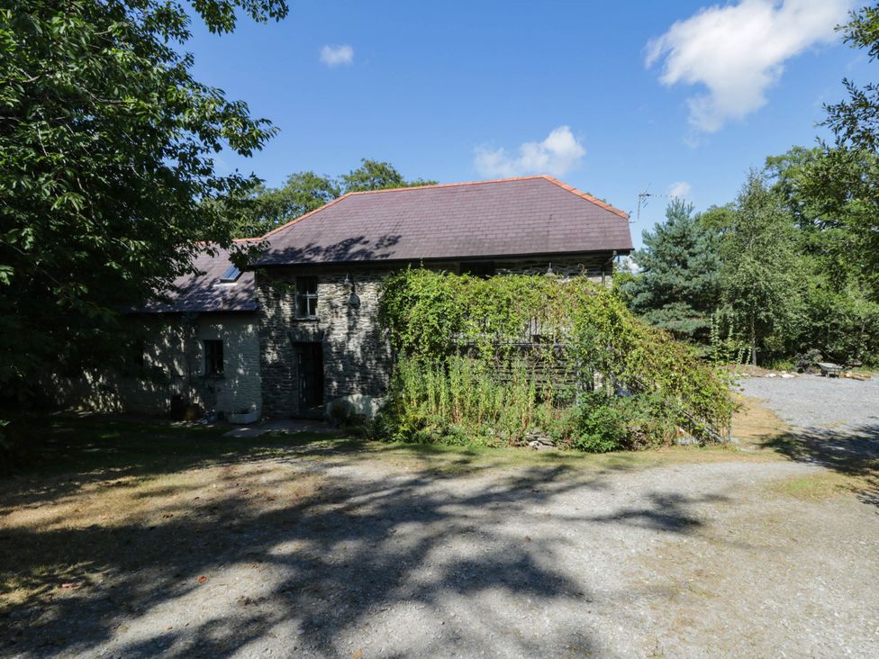 A stone building with plants around it at Yr Hen Felin Boncath
