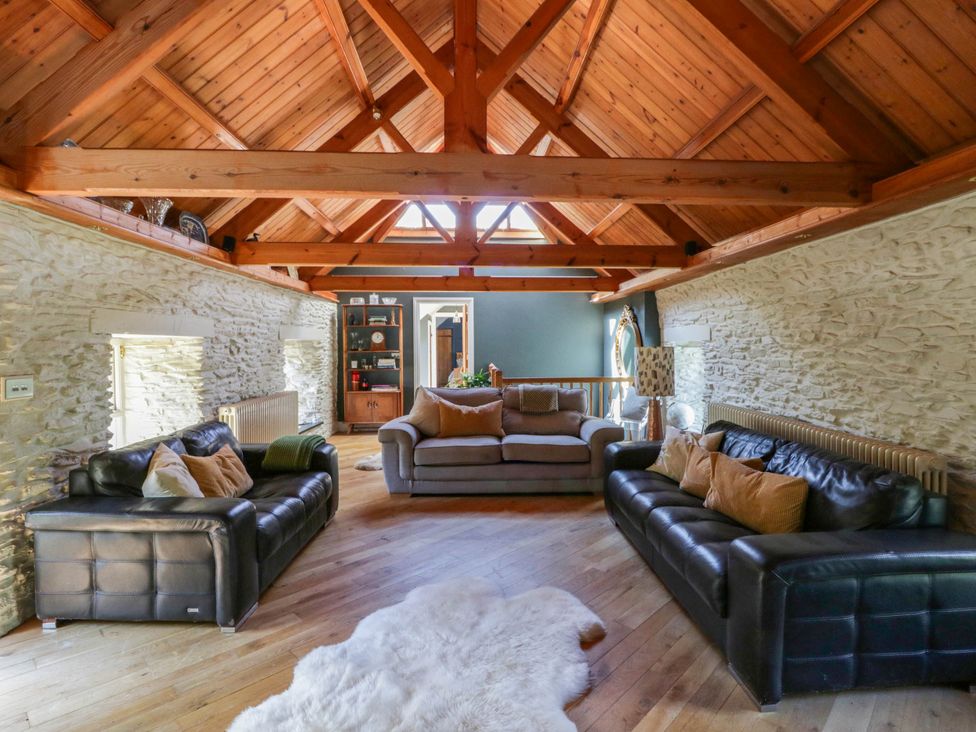 A living room with sofas and a coffee table at Yr Hen Felin in Boncath