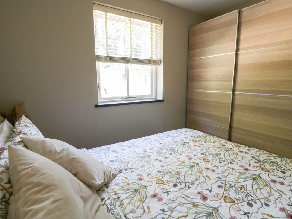 A bedroom with a bed and a window at Yr Hen Felin in Boncath