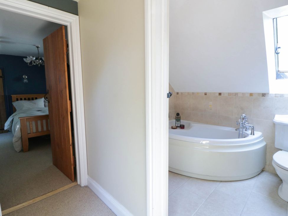 A bathroom with a bathtub and toilet at Yr Hen Felin in Boncath