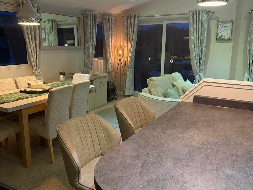 A dining room with a table and chairs at The Stables in Pwllheli