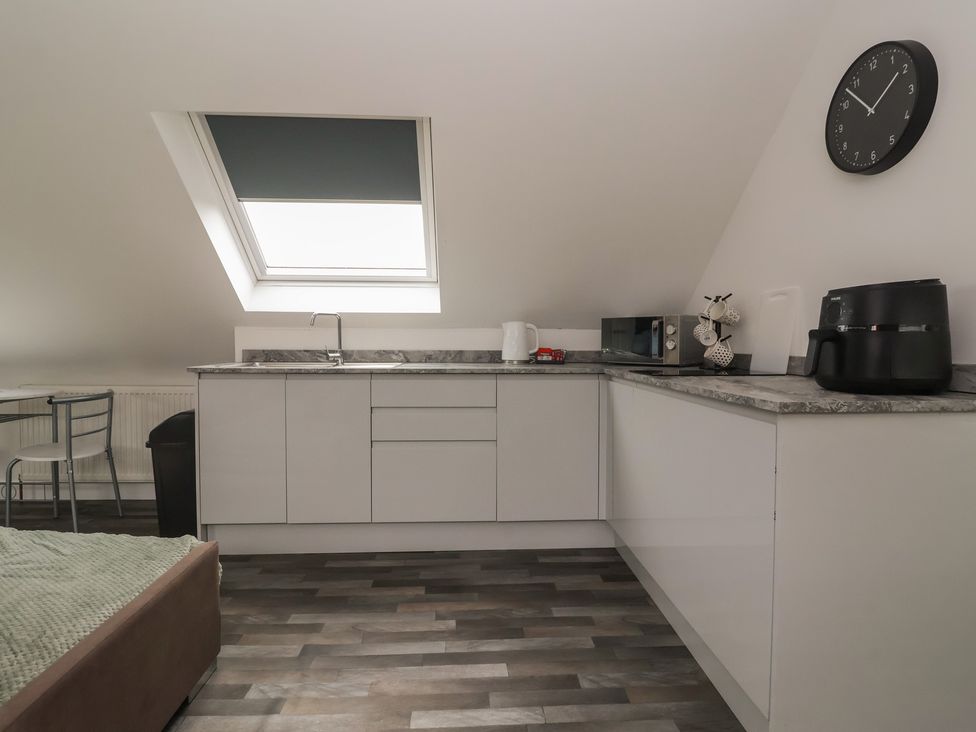 A kitchen with appliances and a table at Fields view in Bridlington