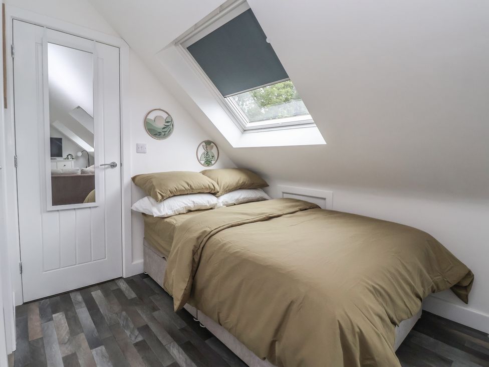 A bedroom with a bed and a mirror at Fields view in Bridlington