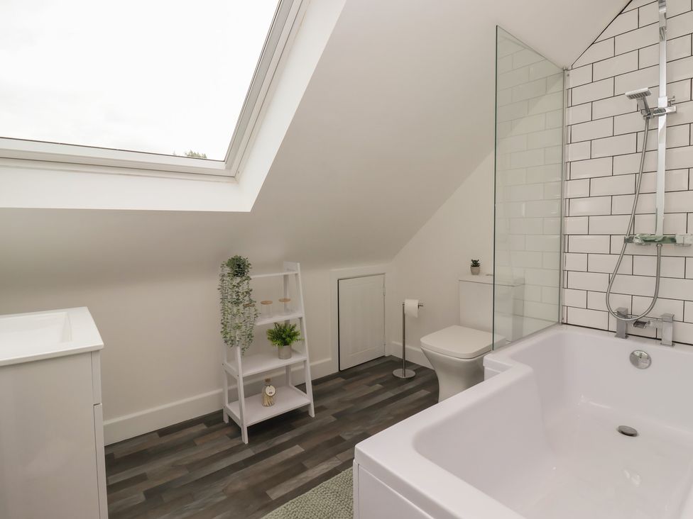 A bathroom with a bathtub and a toilet at Fields view in Bridlington