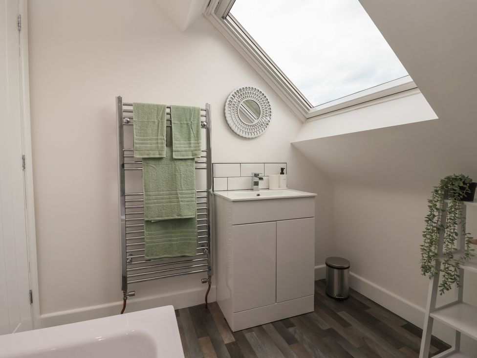 A bathroom with a towel warmer and sink at Fields view in Bridlington