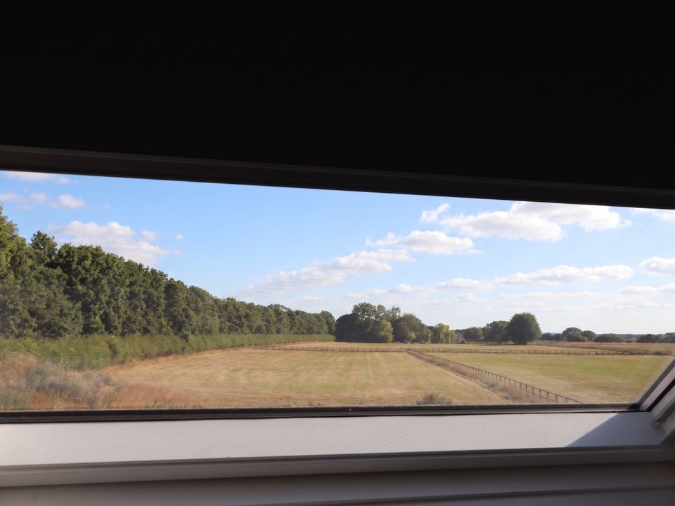 A window view of a field and trees at Fields view in Bridlington