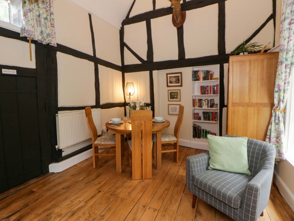 A dining room with a table and chairs at Eightlands in Hereford