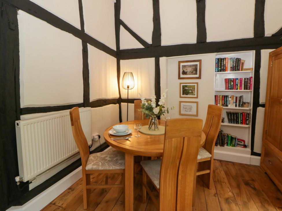 A dining room with a table and chairs at Eightlands Hereford