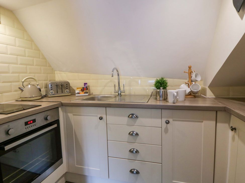A kitchen with a sink, stove and kettle at Eightlands in Hereford
