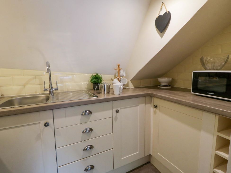 A kitchen with sink and microwave at Eightlands in Hereford