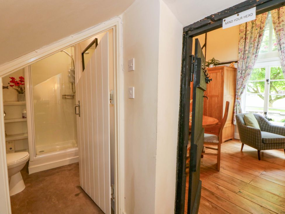 A bathroom with a shower and a dining area at Eightlands in Hereford
