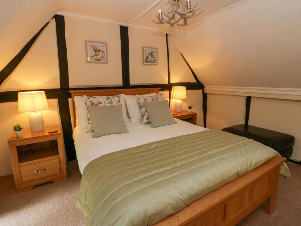 A bedroom with a bed and lamps at Eightlands in Hereford