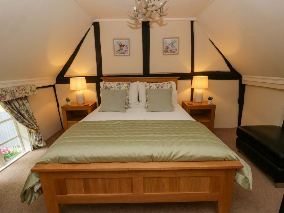 A bedroom with a bed and lamps at Eightlands in Hereford