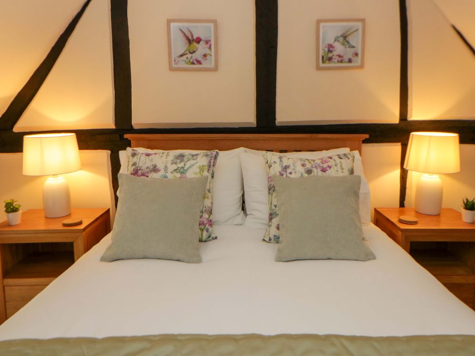 A bedroom with a bed and bedside tables at Eightlands in Hereford
