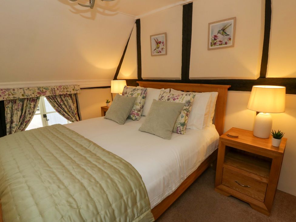 A bedroom with a bed and bedside tables at Eightlands in Hereford