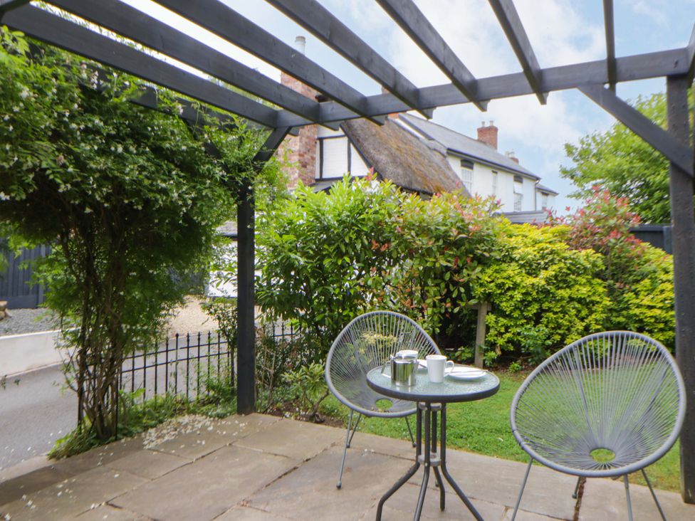 A garden with a table and chairs at Eightlands Hereford