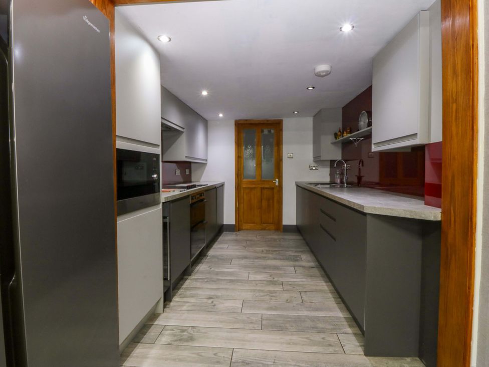 A kitchen with appliances and countertop at Tyr Felin in Caernarfon