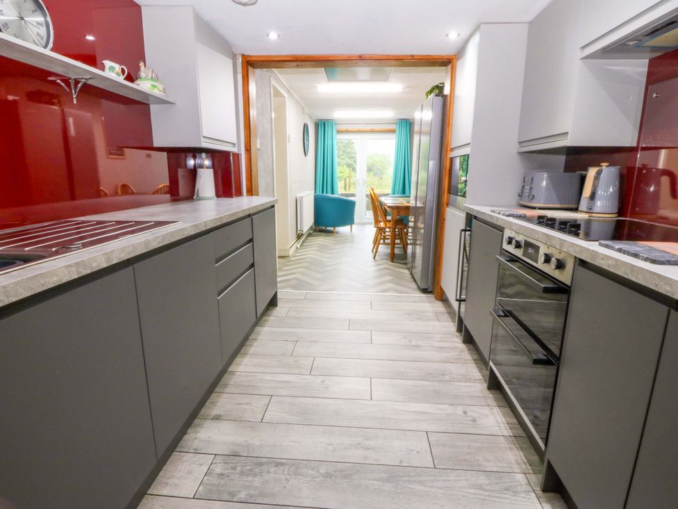 A kitchen with cabinets and appliances at Tyr Felin in Caernarfon