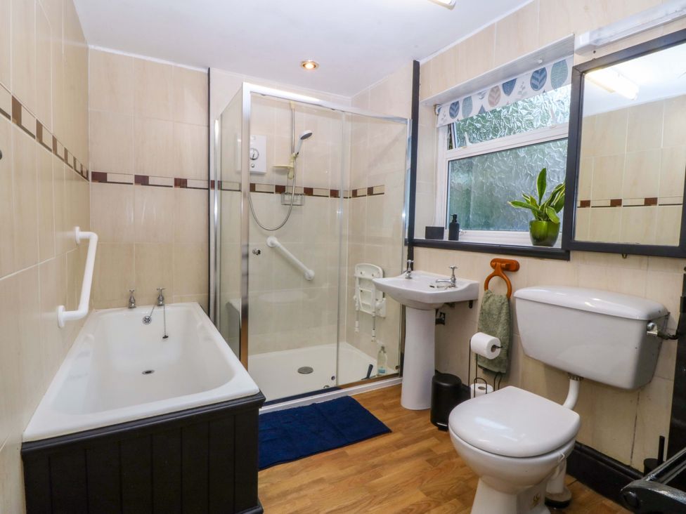 A bathroom with a bathtub and shower at Tyr Felin in Caernarfon