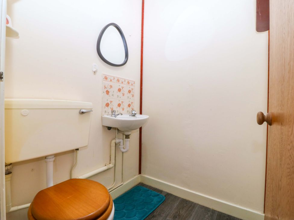 A bathroom with a sink and toilet at Tyr Felin Caernarfon
