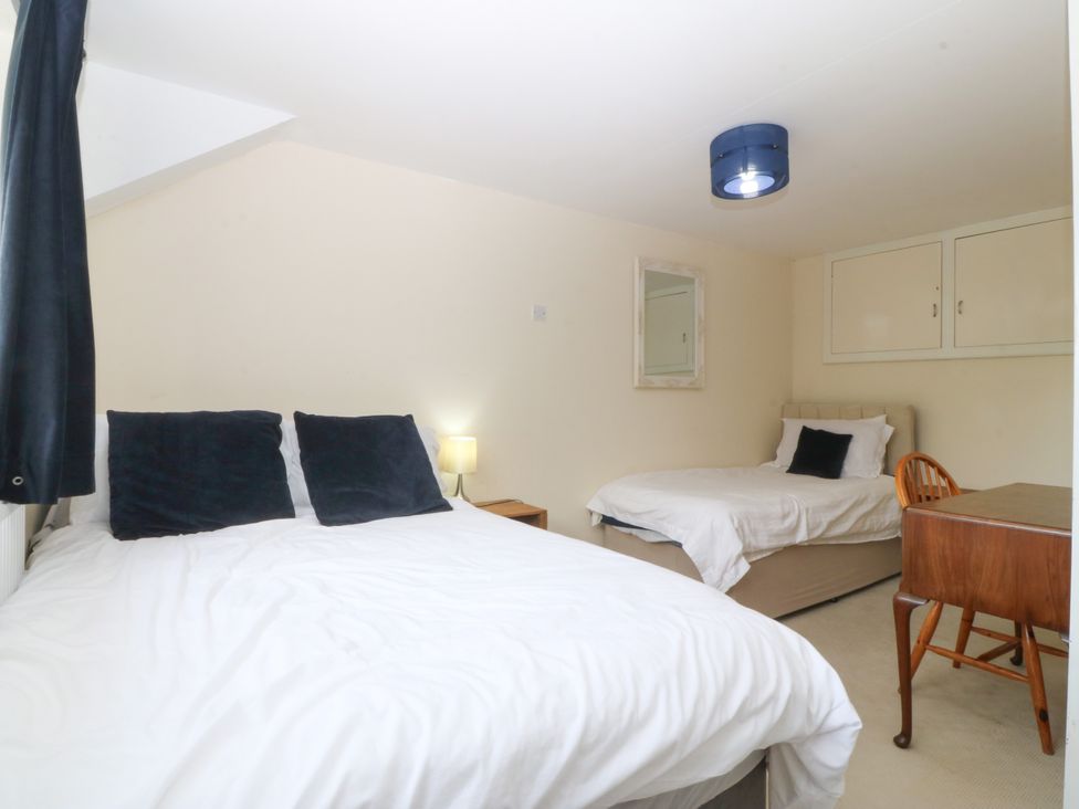 A bedroom with two beds and a lamp at Tyr Felin near Trefor