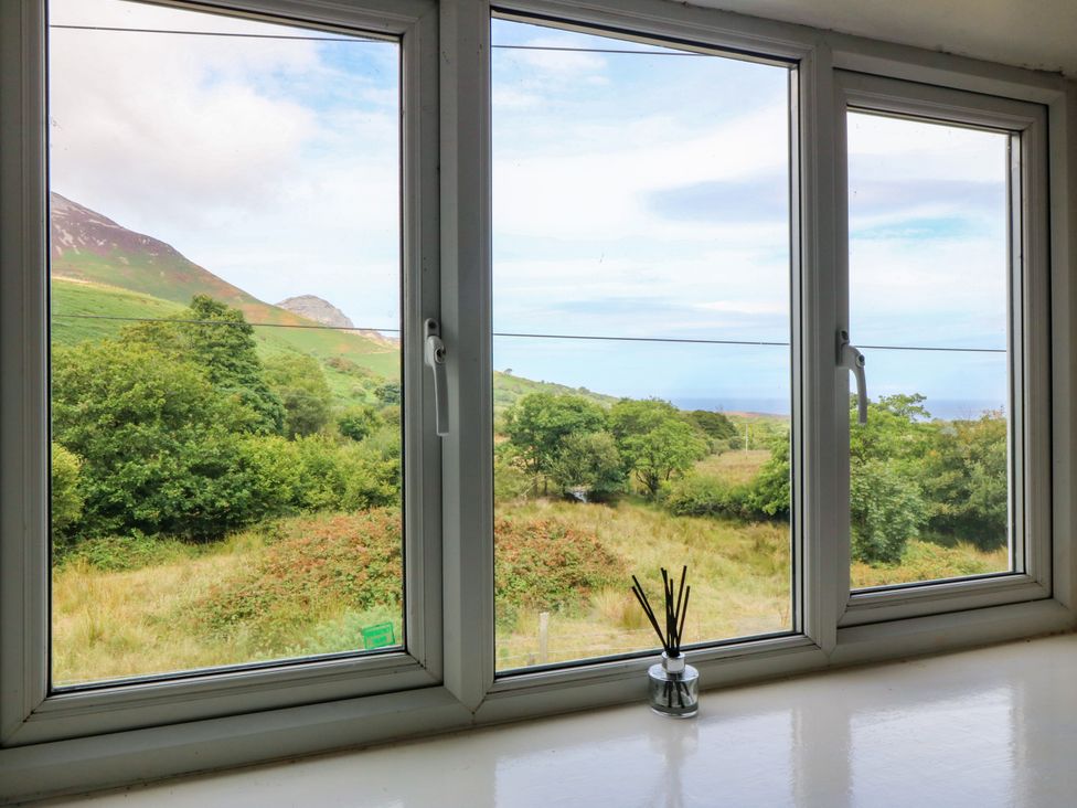 A view through windows showing a landscape at Tyr Felin near Trefor