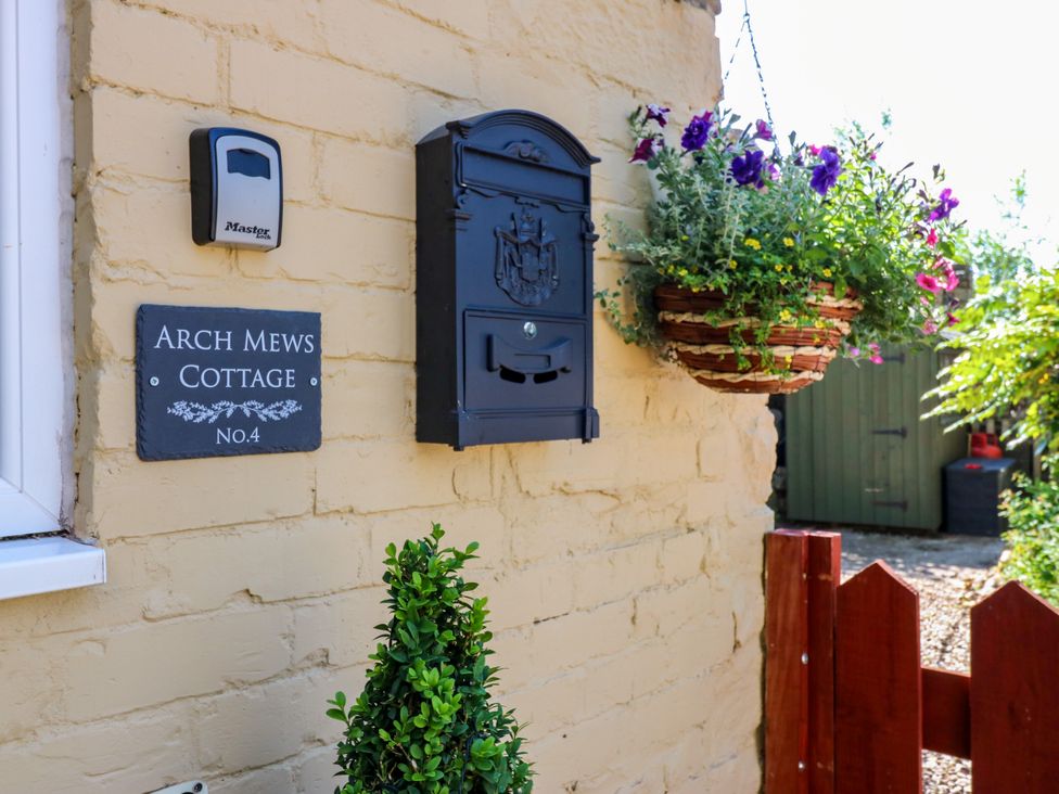 An outdoor wall with a mailbox and address plaque at Arch Mews Cottage Middleton-In-Teesdale