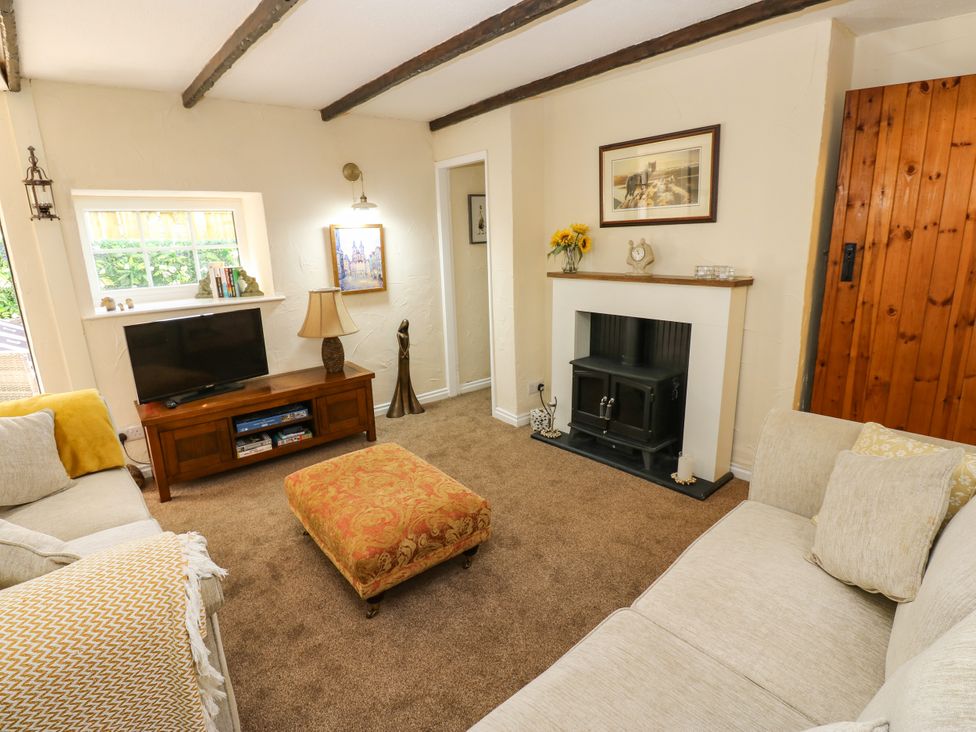 A living room with a television and fireplace at Arch Mews Cottage Middleton-In-Teesdale
