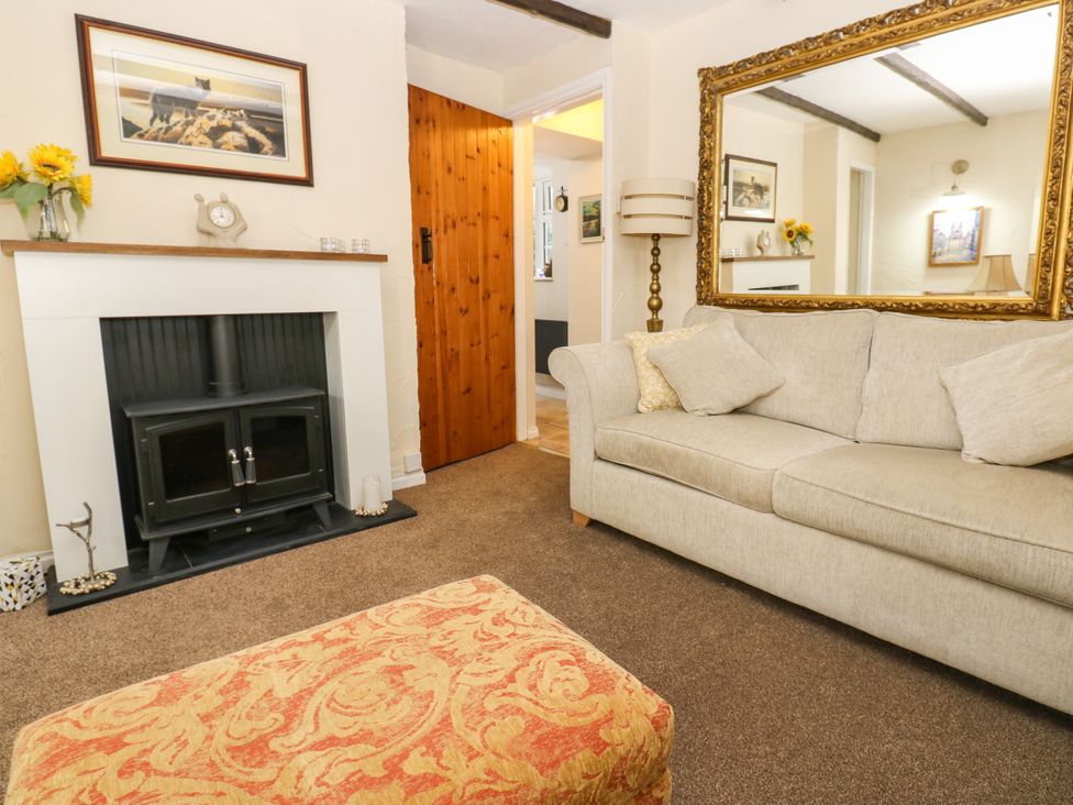 A living room with a fireplace and a sofa at Arch Mews Cottage Middleton-In-Teesdale