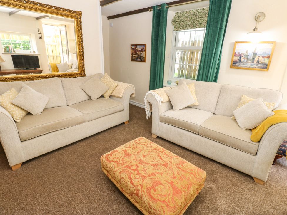 A living room with sofas and a footstool at Arch Mews Cottage Middleton-In-Teesdale