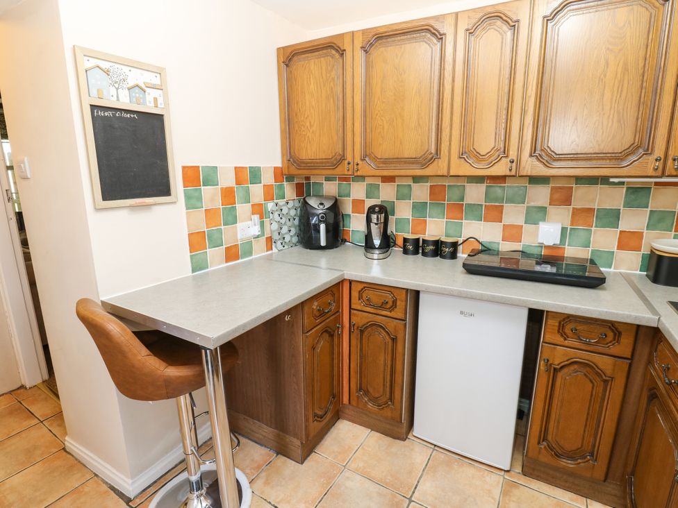 A kitchen with countertop appliances and a bar stool at Arch Mews Cottage Middleton-In-Teesdale
