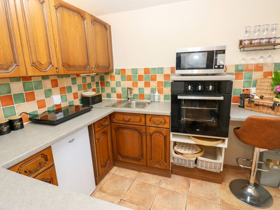 A kitchen with cabinets and appliances at Arch Mews Cottage Middleton-In-Teesdale
