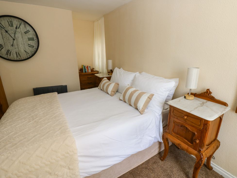 A bedroom with a bed and lamp at Arch Mews Cottage Middleton-In-Teesdale