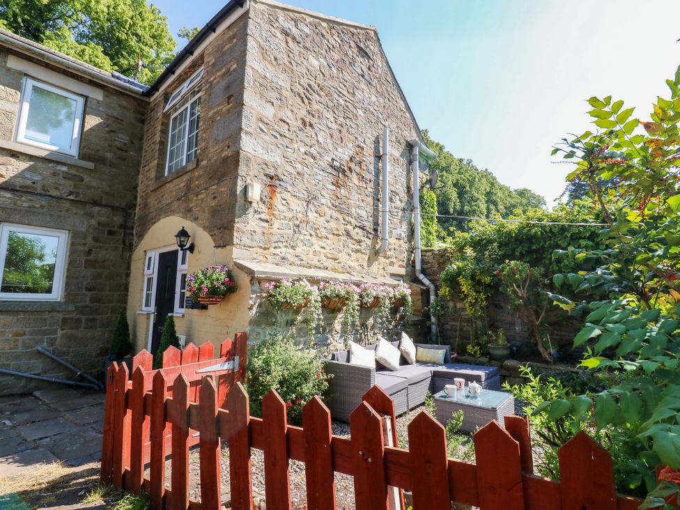 A house exterior with a garden and seating area at Arch Mews Cottage Middleton-In-Teesdale
