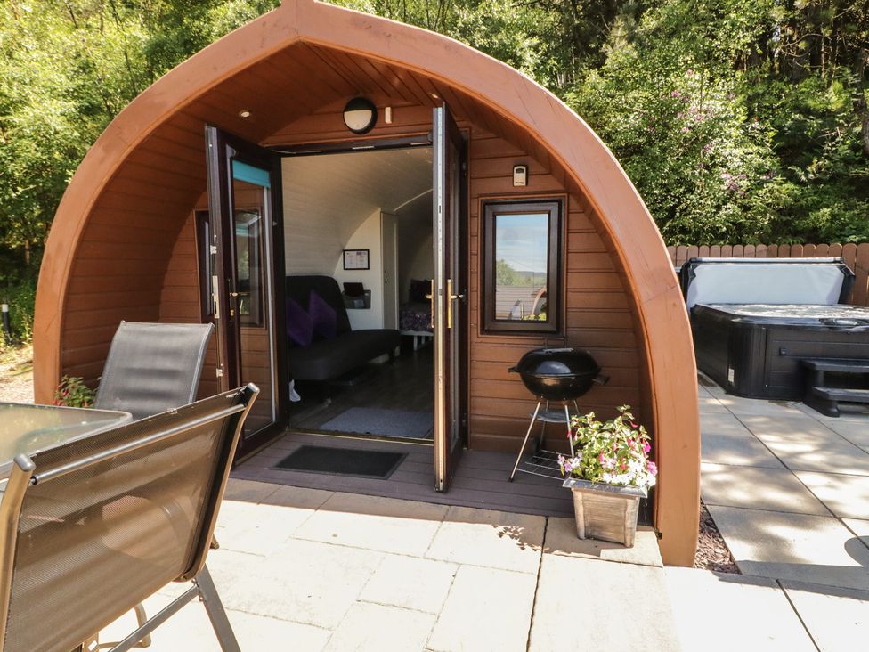 An outdoor glamping pod with a grill and patio at Gortin Glen Glamping Pod 1