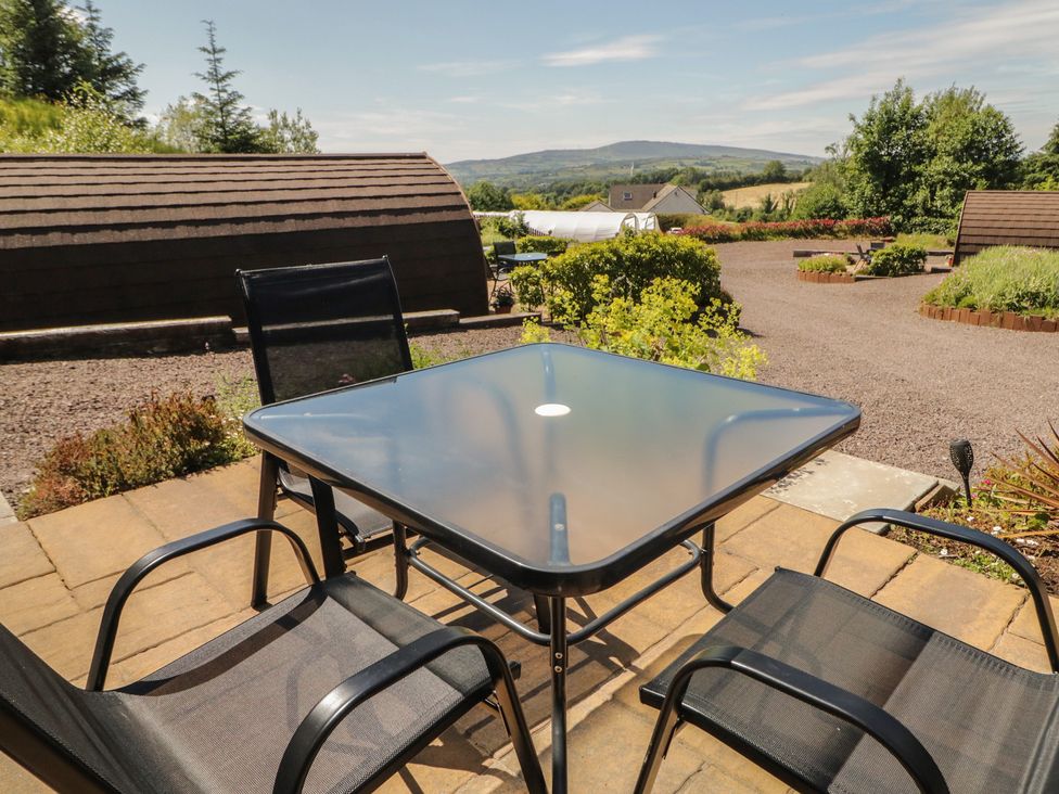 A table and chairs in an outdoor area at Gortin Glen Glamping Pod 1