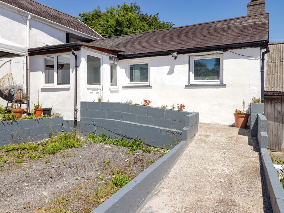 An outdoor view of a house with garden and pathway at Farm Cottage in 