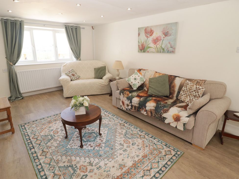 A living room with a sofa and coffee table at Farm Cottage